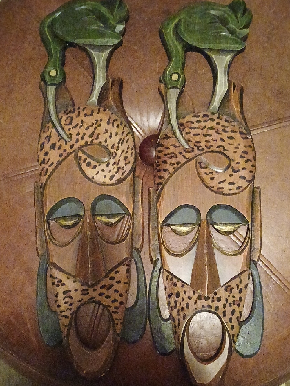 2 Hand carved wooden tribal masks — green and brown pair